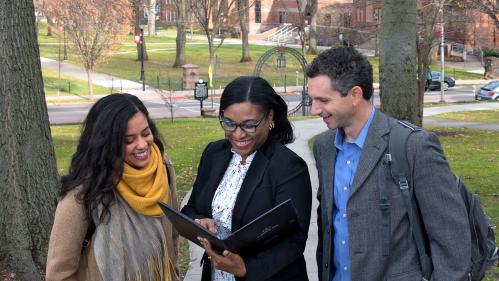 Three faculty members collaborating outdoors