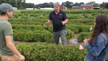 Professor James Simon in the field with two students