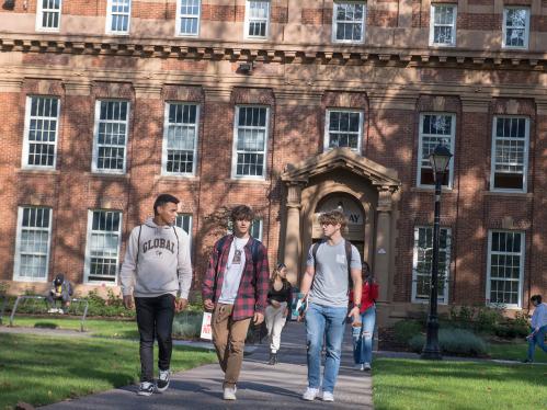 3 male students walking by Murray Hall in New Brunswick 