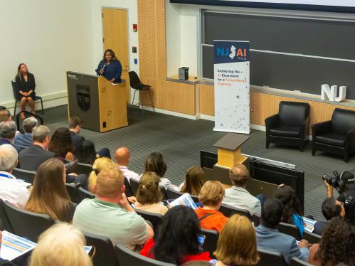 Dr. Arbuthnot speaking at the podium