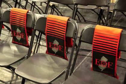 empty chairs with EOF scarfs sitting on the back of the chair